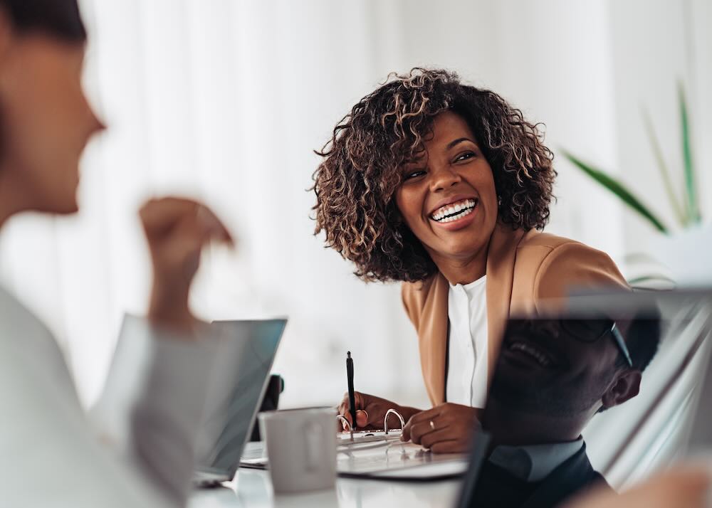 Portrait of a woman smiling at a business meeting