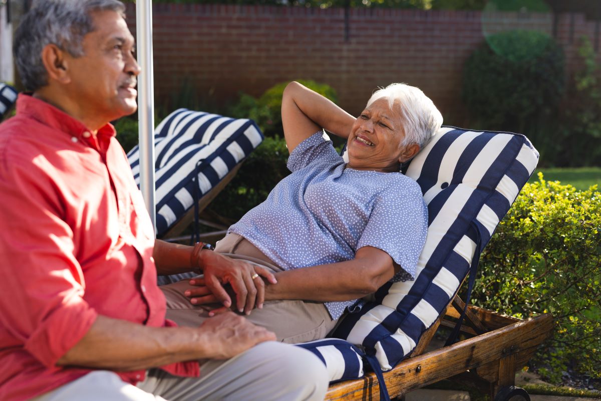 Senior couple resting at their backyard